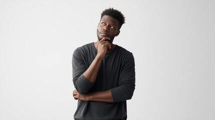 Obraz premium thoughtful african america man 25 years old with fit body, touching his chin
