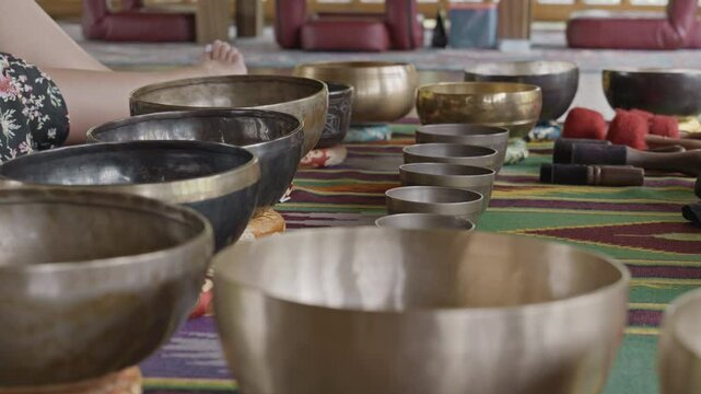 Tebet singing bowls stand on the floor before the start of the bowls ceremony in a gazebo on Bali Island