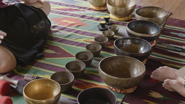 Tebet singing bowls stand on the floor before the start of the bowls ceremony in a gazebo on Bali Island