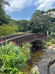 Historic Stone Arch Bridge Over a Stream in Lush Green Landscape