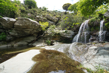 Obraz premium Small Waterfall in Lush Forest on Andros Island, Greece..