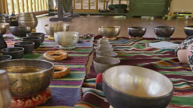 Tebet singing bowls stand on the floor before the start of the bowls ceremony in a gazebo on Bali Island