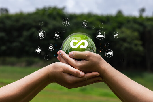Hands Holding Sustainable Globe with Eco-friendly Icons Surrounding