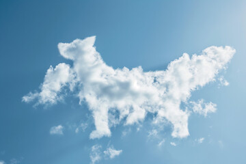 White fluffy clouds shaped like a dog playfully floating in a bright blue sky during a sunny day. Generative AI