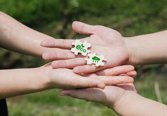 Hands Holding Eco-Friendly Puzzle Pieces for Environmental Awareness