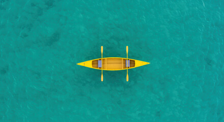 Yellow canoe on teal water