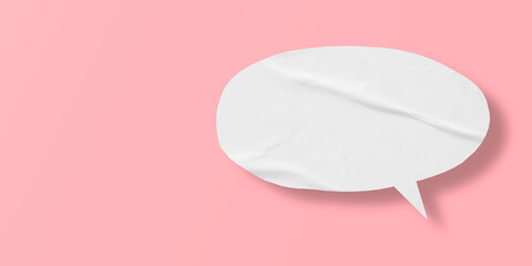 White crumpled speech bubble paper isolated on pink background
