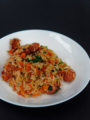 Traditional rustic Brazilian popular food, rice with calabresa sausage and vegetables. Jambalaya