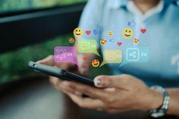 Close-up of hands using smartphone with colorful social media notification icons, representing...