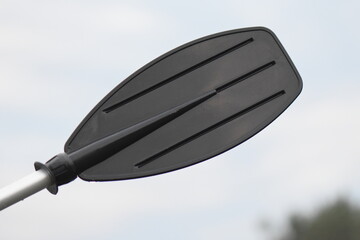 black oar with droplets of water