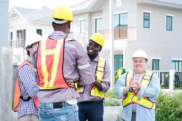 A male engineer wearing a safety helmet is walking to inspect the construction site — an engineer concept.