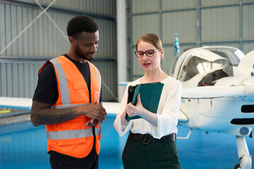 Flight instructor showing aircraft maintenance to trainee pilot