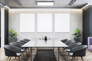 Modern conference room with sleek table and three vertical mockup posters on geometric wall in clean office interior front view. 3D Rendering