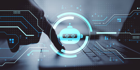 Futuristic chatbot interface with robotic icon overlaying person using laptop for artificial intelligence technology concept on digital background.
