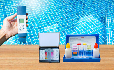 Water quality testing tool over clear swimming pool water background, water tester equipment...