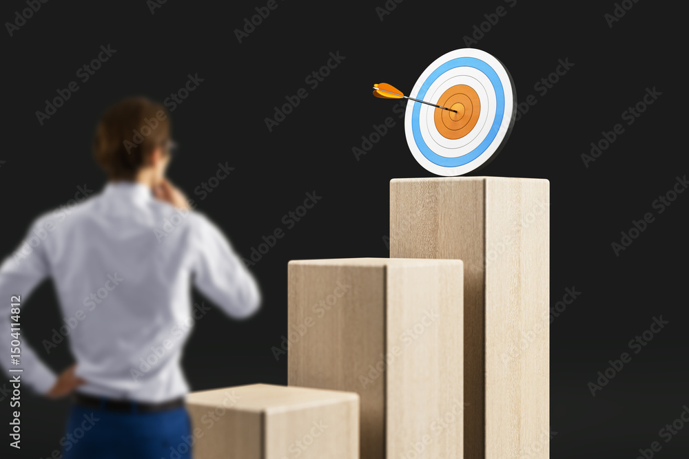 Poster businessperson looking at a bullseye target on top of bar chart blocks symbolizing success and goal 