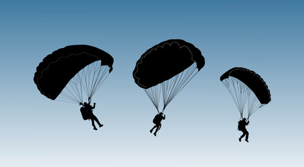 Silhouette of three paragliders descending under large canopies against a clear blue sky. A dramatic skydiving scene.