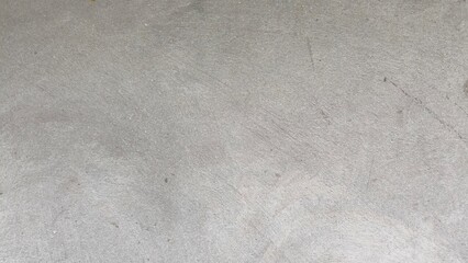 Close-up of a rough gray concrete texture with natural patterns, ideal for use as a background,...