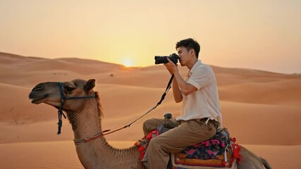Tourist with a camera on a camel in the desert.