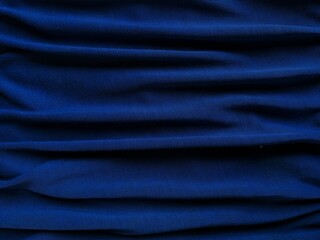 Folded dark blue jeans denim texture background. horizontal folded.