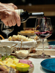 Wine being poured into a glass with food, creating a delightful scene