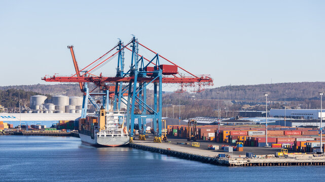 Gothenburg / Sweden, Mar 21, 2025: Container ship being loaded by gantry cranes at Skandiahamnen, Port of Gothenburg.