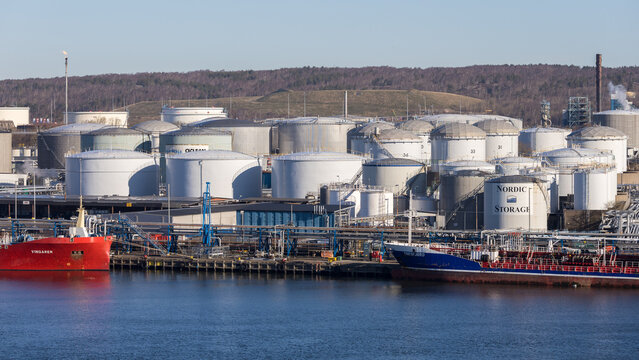 Gothenburg / Sweden, Mar 21, 2025: Nordic Storage tank farm with tanker Vingaren at the Port of Gothenburg.