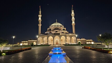 Illuminated Sharjah Mosque & Water Canal at Night – Stunning Reflections, Vibrant City Lights, and Majestic Architecture Capturing UAE’s Cultural Beauty