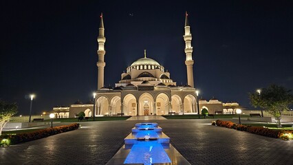 Illuminated Sharjah Mosque & Water Canal at Night – Stunning Reflections, Vibrant City Lights, and Majestic Architecture Capturing UAE’s Cultural Beauty