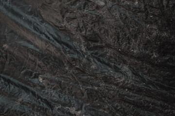 crumpled or abstract texture on abstract background. dark black grunge wrinkled pattern