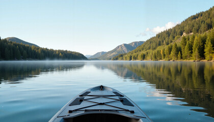 Obraz premium Scenic kayak view on calm lake surrounded by mountains and trees 