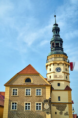 historic town hall with sundial and tower in Otmuchow