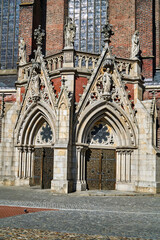 medieval facade of a gothic church with stone portals in the city of Nysa