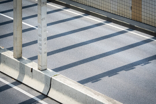 Shadow of the railing at the tunnel entrance