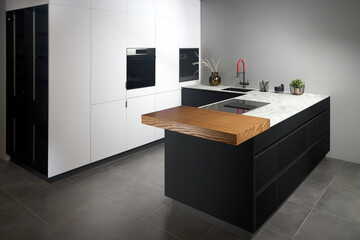 Upscale modern flat design loft kitchen with Induction cooker black glass hob with integrated hood...