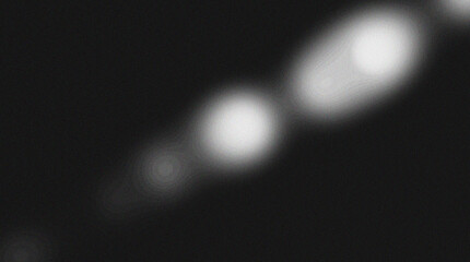 Abstract bokeh lights in dark background. Two bright light spots. Blurred light streaks. Abstract texture background.