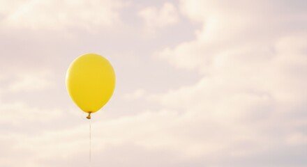 Obraz premium Yellow balloon floating against soft clouds in the sky 