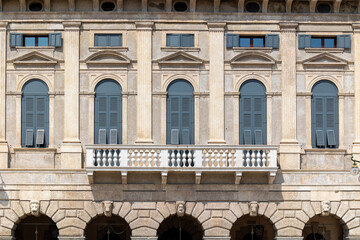 Classical European Building Facade with Neoclassical Architecture, Columns and Blue Shutters