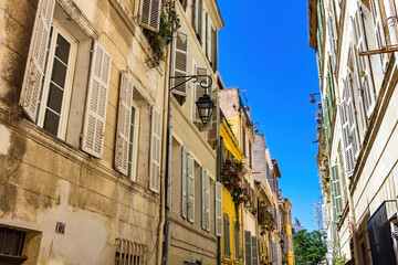 Old French houses narrow street in Le Panier area of Marseille, France