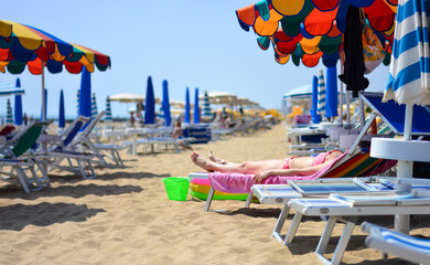 the woman on the deckchair on the beach
