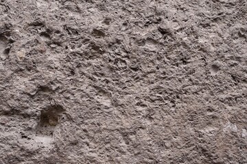 Old stone, concrete wall texture close-up. Wall background with rough stone surface