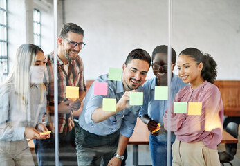 Business people meeting at office and using sticky notes on glass to share idea. Brainstorming and...