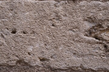 Old stone, concrete wall texture close-up. Wall background with rough stone surface