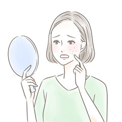 手鏡を見て湿疹にショックを受ける女性