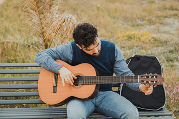 Man Immersed in the Music of His Guitar Outdoors