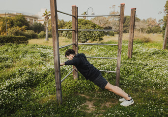 Man Works Out in Spring Outdoors Doing Push Ups