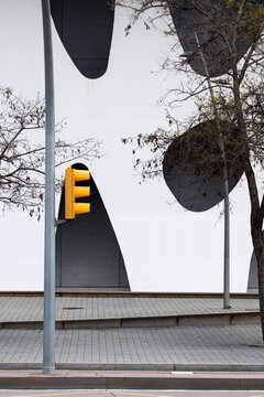 Yellow traffic lights by minimalist grey urban wall, geometric contrast and light for background, design and visual storytelling in modern city infrastructure.