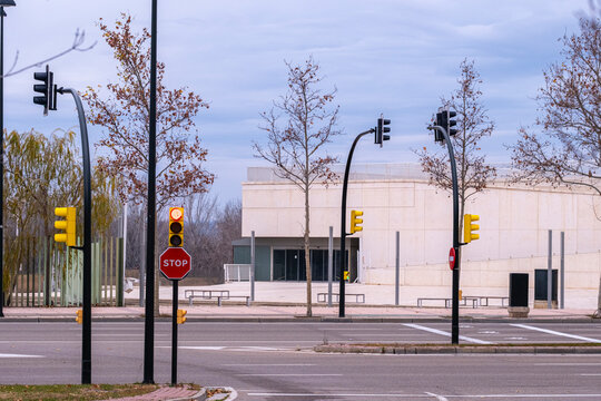 Traffic lights in a wide empty road scene, clean lines, modern architecture and color contrast, ideal for urban design, background visuals and business concepts.