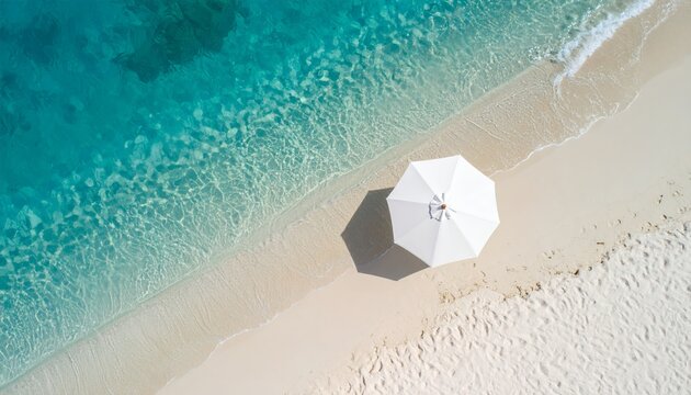 Breathtaking aerial view of a pristine tropical beach with crystal-clear turquoise water and a white umbrella providing shade. Perfect for travel and vacation themes!