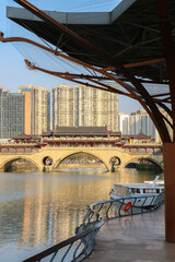 Vertical shot of the iconic ancient Chinese Anshun Bridge in Chengdu over the Jinjiang River, seen from the Hejiangting wharf on a sunny day